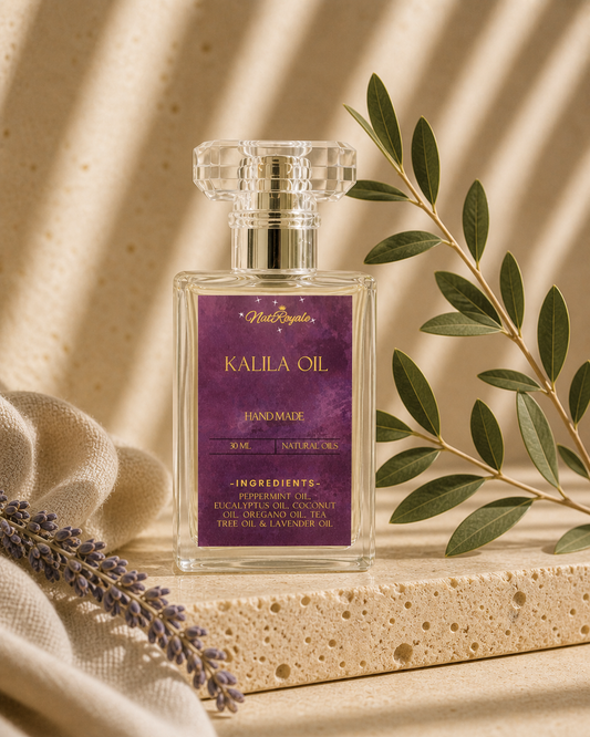 Kalila Oil by Natroyale — botanical body and pulse-point oil in a clear glass bottle with deep purple label, on a travertine stone shelf with fresh lavender and olive branch.
