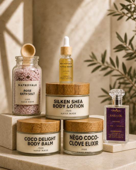 The Natroyale Ritual Set — Silken Shea Body Lotion, Coco Delight Body Balm, Royale Serum, Rose Bath Salt and Kalila Oil styled together on a stone surface with olive leaves — luxury natural bodycare gift bundle handmade in the UK.